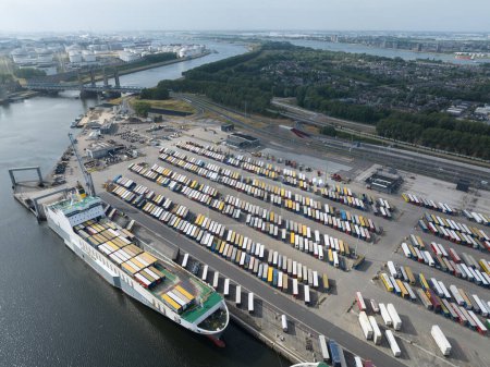 Photo for Botlek, Rotterdam, 2nd of July, The Netherlands. Intermodal transport terminal at the harbour of Rotterdam. Trucks lining up ready for transport. - Royalty Free Image