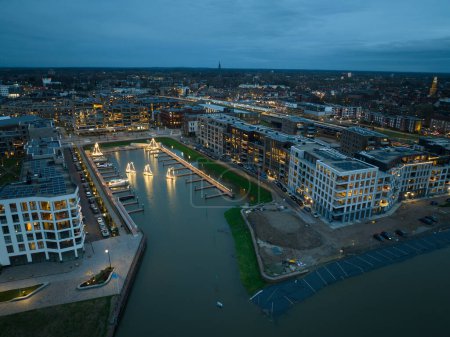 Photo for Aerial drone view of new build residential building at the Noorderhaven in Zutphen at dusk. The Netherlands. - Royalty Free Image