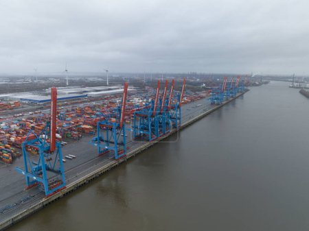 Photo for Hamburg, Germany, December 30th, 2023: Altenwerder container terminal, loading and unloading of containers on transportation ships. - Royalty Free Image