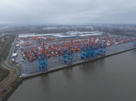 Photo for Hamburg, Germany, December 30th, 2023: Altenwerder container terminal, loading and unloading of containers on transportation ships. - Royalty Free Image