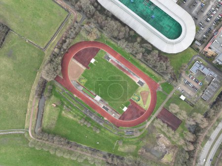 Top down view on a running track layout. Oval athletics track a sports field on which athletics competitions are held. Running piste outdoor.