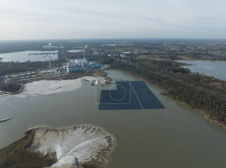 Aerial drone view on solar panels on water. Quarry and sand extraction.