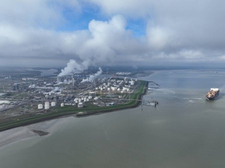 Aerial drone view of a chemical park like Dow in Terneuzen, focusing on chemical production, storage, distribution, and access through various transportation modes. The Netherlands.
