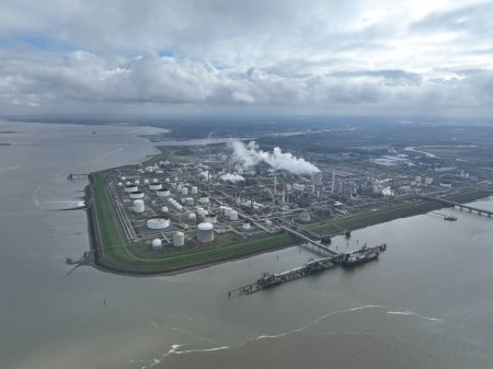 Aerial drone view on one of the largest chemical clusters in northwestern Europe, chemical park Dow in terneuzen, Chemical industry facilities, storage silos, containers and smoke stacks in operation.