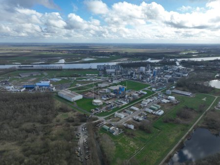 Aerial drone view agricultural industrial installation along the Ghent Terneuzen canal. Processing, distribution and trading of agricultural products.