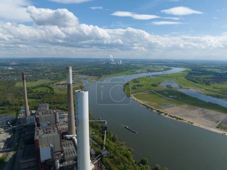 The Ruhr area is a highly industrialized region in the German state of North Rhine Westphalia. Here we see the rhine river and industrial powerplant. important places are Duisburg , Essen , Bochum
