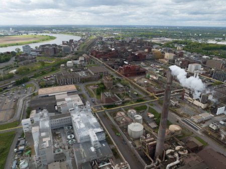 Smoking smoke stack at chemical park in the german Ruhr Area. Heavy industry, 4K Aerial drone view. Industry and production.