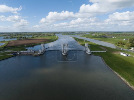 Aerial drone views of a hydroelectric or hydraulic power station in Maurik, Netherlands, emphasizing its sustainable energy generation