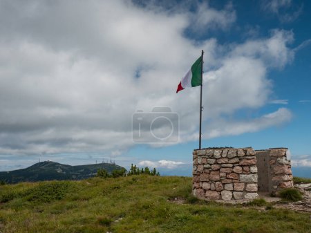 Photo for Italian flag at Canfedin view. Summer meadow close to peak of Gazza mountain above Andalo town. Summer Dolomite Alps. Vezzano region, Trentino, Italy - Royalty Free Image