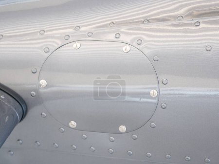 Photo for Screwed cover on plane body. Detail of smalll airplane body. Ultralight plane or drone,  aluminum cover with rivets. Airplane airframe close-up - Royalty Free Image