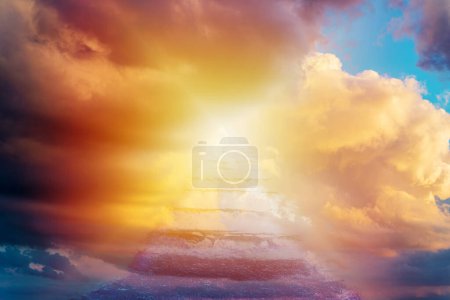 Beautiful religious background.Sunset or sunrise with clouds,blurred stairs to heaven,sunlight from heaven,stairway leading up to skies clouds.Light from sky.Religion concept.Blurred soft focus.