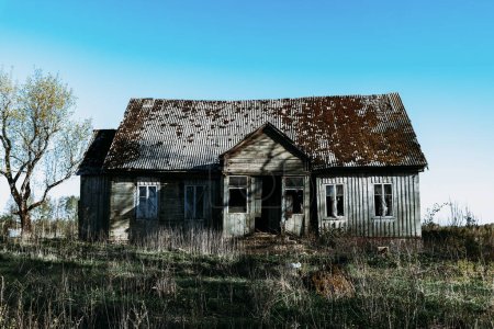 Téléchargez les photos : Maison abandonnée du 19ème siècle dans un champ rural à l'été.Soirée d'été effrayante.Tonique. - en image libre de droit