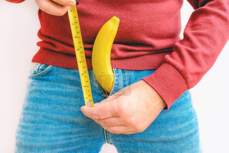 Photo for Penis size measurement.Man Banana with measurement tape, penis size concept - Royalty Free Image