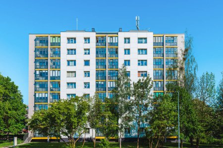 White mockup, Multi-apartment renovated residential building blue sky summer.