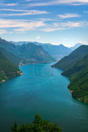 Photo for Scenic view over the city of Lugano, the Lugano Lake and mountain peaks of Swiss Alps, visible from Monte San Salvatore observation terrace, canton of Ticino, Switzerland. - Royalty Free Image