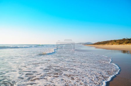 Photo for Beautiful panorama of the Peregian Beach nestled against the dunes of a pristine white sand beach with surfing breaking waves on the Sunshine Coast, Queensland, Australia. Spectacular landscape of the Pacific Ocean on a sunny day. - Royalty Free Image