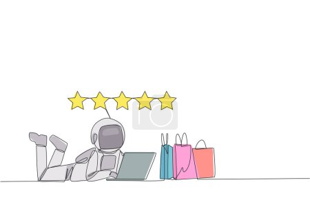 Single continuous line drawing young astronaut on stomach while typing on laptop. Next to the laptop is shopping bag. Give the best review with pleasure. Spaceman. One line design vector illustration