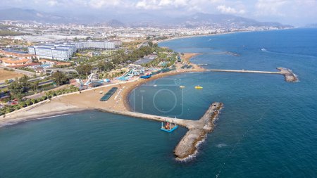 Photo for Aerial drone photo of the beautiful town of Alanya, a resort town on Turkeys central Mediterranean coast showing a hotel and vacation holiday resort from above in the summer time - Royalty Free Image