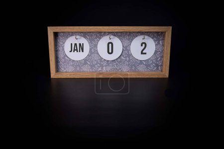 Photo for A wooden calendar block showing the date January 2nd on a dark black background 2nd day of the year concept - Royalty Free Image