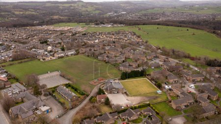 Foto de Aerial drone photo of the Village of Netherton near Huddersfield, in the Kirklees metropolitan borough of West Yorkshire, England showing the residential houses in the winter time - Imagen libre de derechos