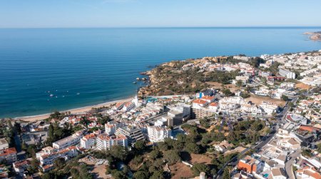 Photo for Aerial photo of the beautiful town in Albufeira in Portugal showing the Praia da Oura golden sandy beach, with hotels and apartments in the town, taken on a summers day in the summer time. - Royalty Free Image