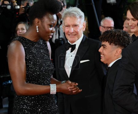 Photo for CANNES, FRANCE. May 18, 2023: Shaunette Renee Wilson, Harrison Ford and Ethann Isidore at the premiere of Indiana Jones and the Dial of Destiny at the 76th Festival de Cannes - Royalty Free Image