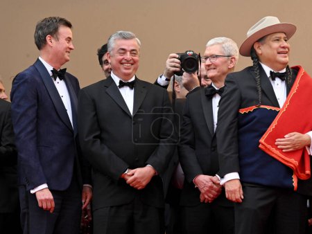 Photo for CANNES, FRANCE. May 20, 2023: Zack Van Amburg, Eddy Cue, Tim Cook and Yancy Red Corn at the Killers of the Flower Moon premiere at the 76th Festival de Cannes - Royalty Free Image