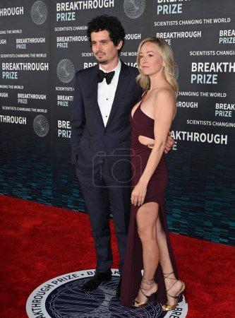 Photo for LOS ANGELES, CA. April 15, 2023:  Damien Chazelle and Olivia Hamilton at the 2023 Breakthrough Prize Ceremony for Science and Mathematics at the Academy Museum - Royalty Free Image