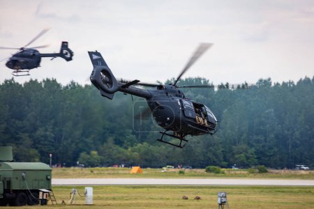 Foto de Kecskemet, Hungary - August 28, 2021: Military helicopter at air base. Air force flight transportation. Aviation and rotorcraft. Transport and airlift. Military industry. Fly and flying. - Imagen libre de derechos