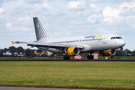 Photo for Amsterdam, Netherlands - August 14, 2014: Vueling passenger plane at airport. Schedule flight travel. Aviation and aircraft. Air transport. Global international transportation. Fly and flying. - Royalty Free Image