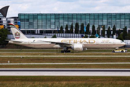 Photo for Munich / Germany - July 11, 2017: Etihad Airways Boeing 777-300ER A6-ETS passenger plane departure and take off at Munich Airport - Royalty Free Image