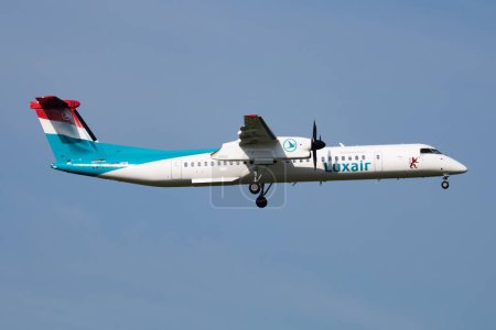 Photo for Vienna, Austria - May 20, 2018: Luxair Bombardier DHC-8 Q400 LX-LQI passenger plane arrival and landing at Vienna Airport - Royalty Free Image