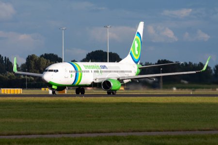 Photo for Amsterdam, Netherlands - August 15, 2014: Transavia passenger plane at airport. Schedule flight travel. Aviation and aircraft. Air transport. Global international transportation. Fly and flying. - Royalty Free Image