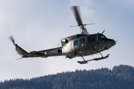 Photo for Zell am See, Austria - February 19, 2018: Military helicopter at air base. Air force flight transportation. Aviation and rotorcraft. Transport and airlift. Military industry. Fly and flying. - Royalty Free Image