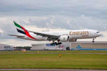 Photo for Amsterdam / Netherlands - August 16, 2014: Emirates SkyCargo Boeing 777-200 A6-EFG cargo plane arrival and landing at Amsterdam Schipol Airport - Royalty Free Image