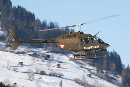 Photo for Zell am See, Austria - February 19, 2018: Military helicopter at air base. Air force flight transportation. Aviation and rotorcraft. Transport and airlift. Military industry. Fly and flying. - Royalty Free Image