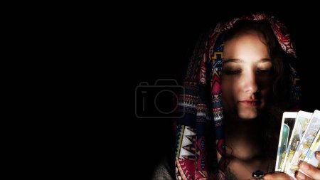 Young Girl in Headscarf Pose Holding Tarot Cards  Photo
