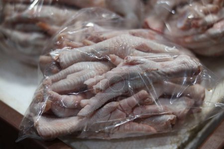 Photo for Plastic bag of raw chicken feet on display for sale in market. High quality photo - Royalty Free Image