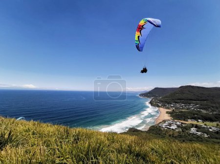 Photo for 24 November 2022 - Stanwell Park, NSW, Australia: Hanglider high over beach. High quality photo - Royalty Free Image
