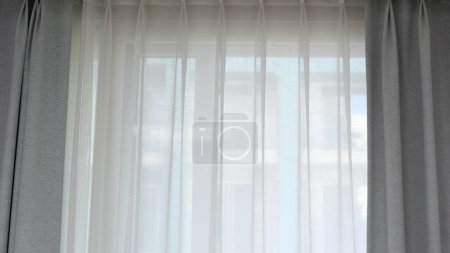 Photo for Voile curtain in front of window with grey pleated curtains to either side. High quality photo - Royalty Free Image