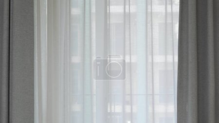 Photo for Voile curtain in front of window with grey pleated curtains to either side. High quality photo - Royalty Free Image