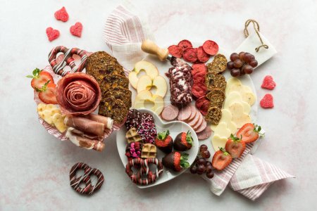 Photo for A top down view of a Valentines day charcuterie arrangement against a light background. - Royalty Free Image