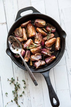 Foto de Horno de cebolla roja asada con tomillo y vinagre balsámico, en un frypan de hierro fundido. - Imagen libre de derechos
