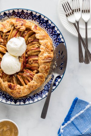 A Salted caramel apple galette hot out of the oven, served with vanilla ice cream.