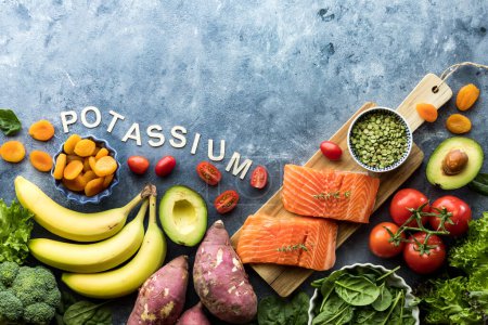 Photo for Top down view of various healthy raw foods high in potassium with copy space above. - Royalty Free Image