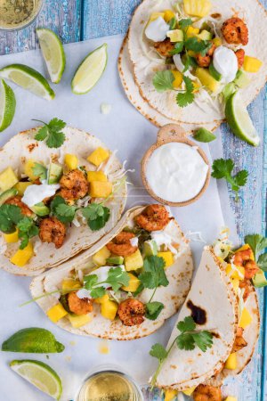 Photo for Fresh and healthy spicy shrimp tacos with lime yogurt sauce and cilantro. - Royalty Free Image