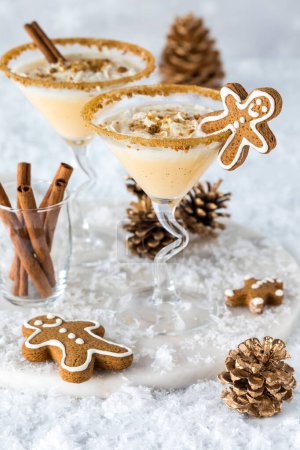 Refreshing gingerbread martini cocktails with festive decorations and gingerbread cookies. 