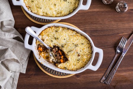 Photo for Top down view of casserole dishes of homemade cauliflower shepherds pie, ready for eating. - Royalty Free Image