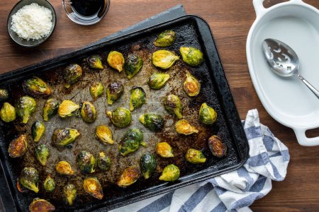 Photo for Top down view of roasted brussel sprouts on a sheet pan fresh out of the oven. - Royalty Free Image