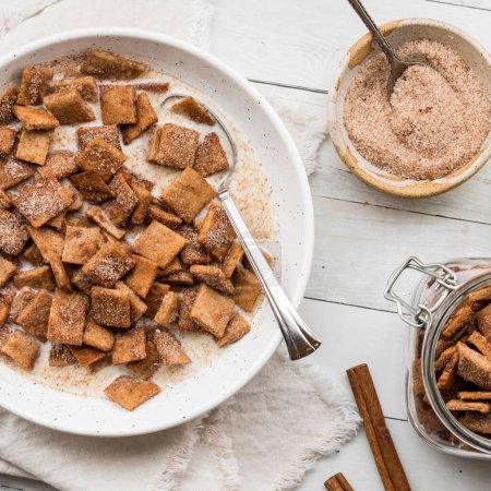 Photo for Above view of a bowl of homemade low carb cinnamon toast crispy cereal served with fresh milk. - Royalty Free Image
